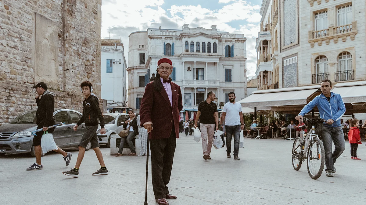 FILE PHOTO: A man in traditional Tunisian dress poses for a photo at Tunisia's landmark 'Bab el Bhar ("the sea gate").