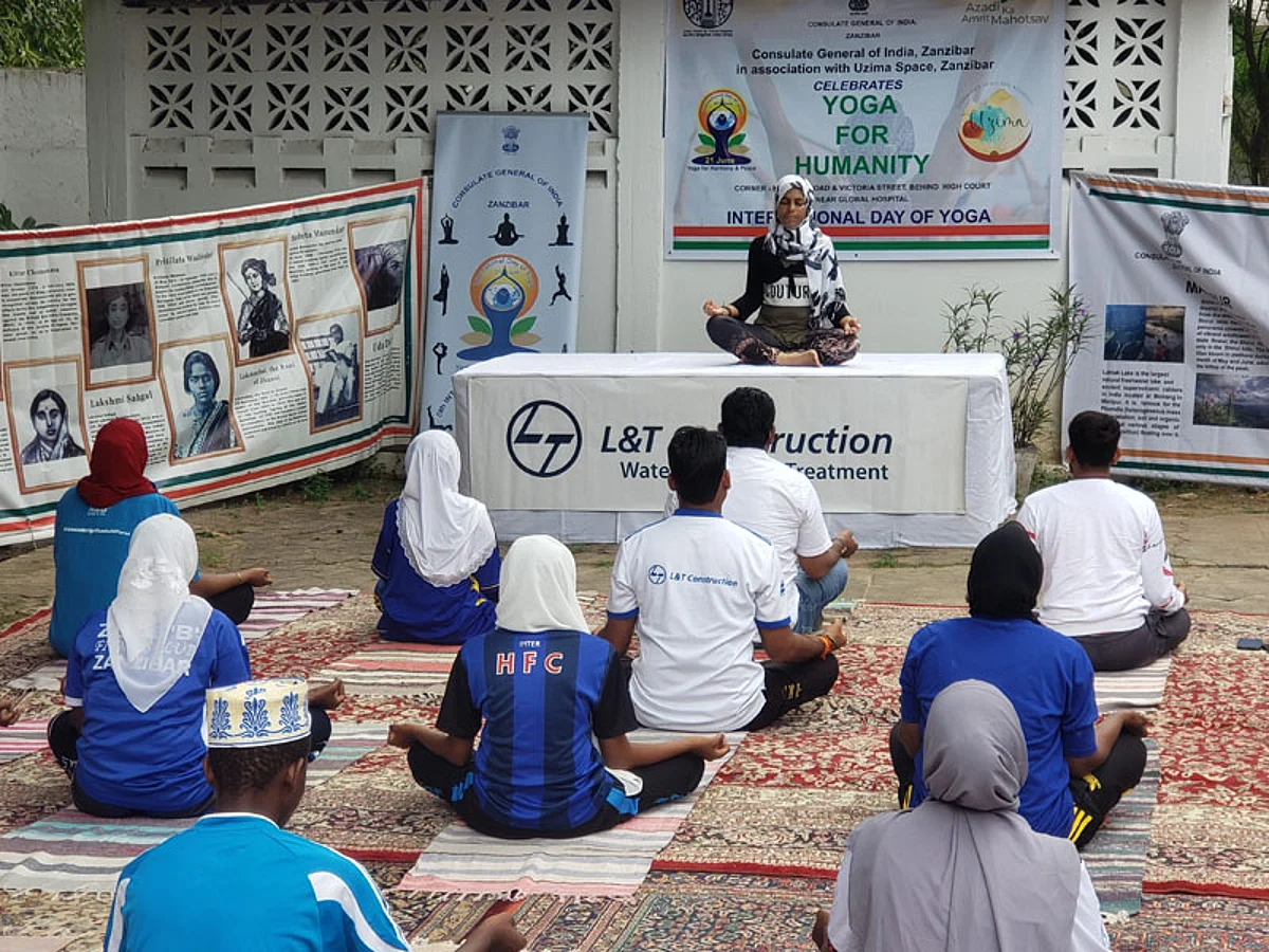 The Yoga instructor and participants perform a meditation session in Zanzibar, Tanzania.