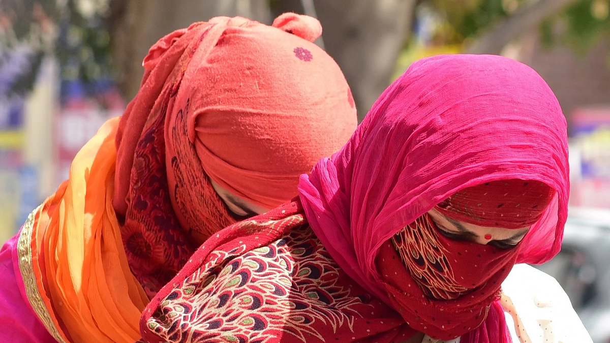 Women cover their faces to avoid scorching sun on a hot day. (File Photo: IANS) 