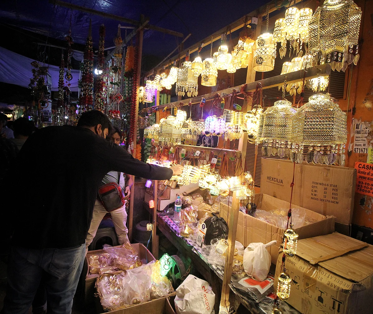 A vendor sells handicraft decorative lamps at Bhagirath Place