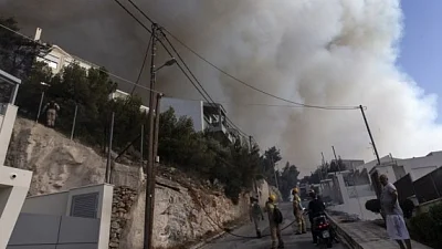 Wildfire rages in Athens, homes evacuated