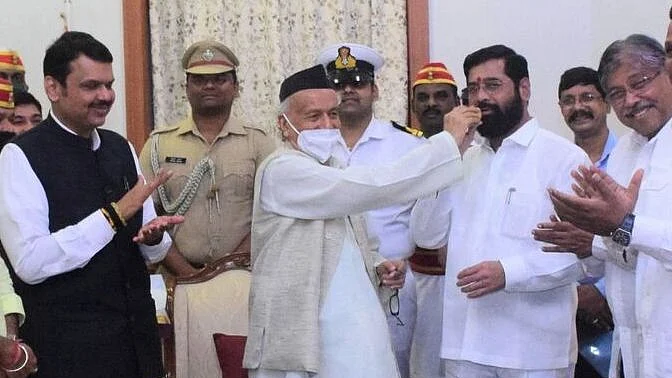 Mission Accomplished? Maharashtra Governor BS Koshyari (centre) feeds sweets to Shiv Sena rebel Eknath Shinde after administering oath as CM to the latter