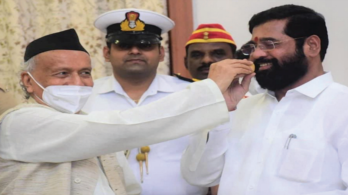 Governor BS Koshyari feeds laddoos to Shiv Sena rebel Eknath Shinde soon after the latter took oath as CM of Maharashtra