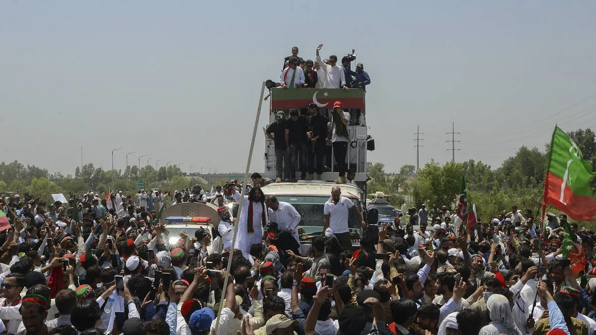 Former Pakistan PM Imran Khan waves at his supporters during the long march