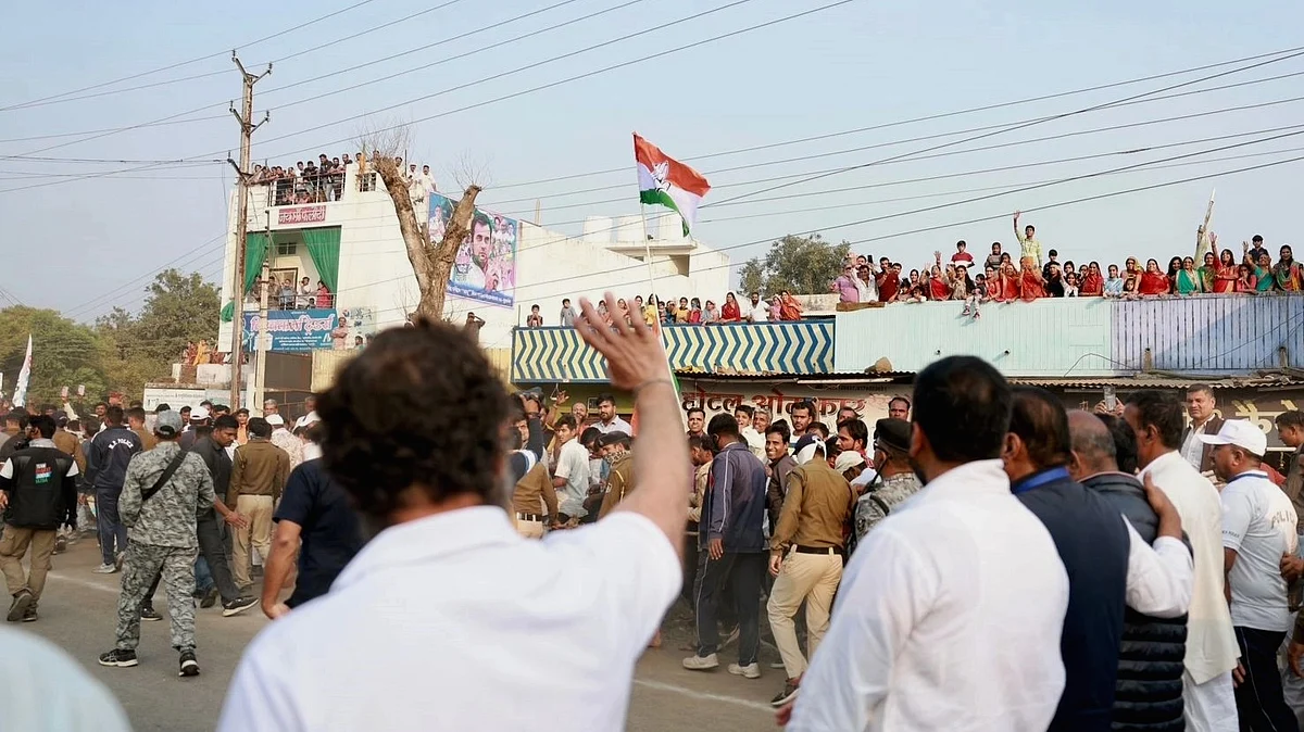 Rahul Gandhi waves back at people greeting him from rooftops during the Bharat Jodo Yatra on Sunday, Dec. 4