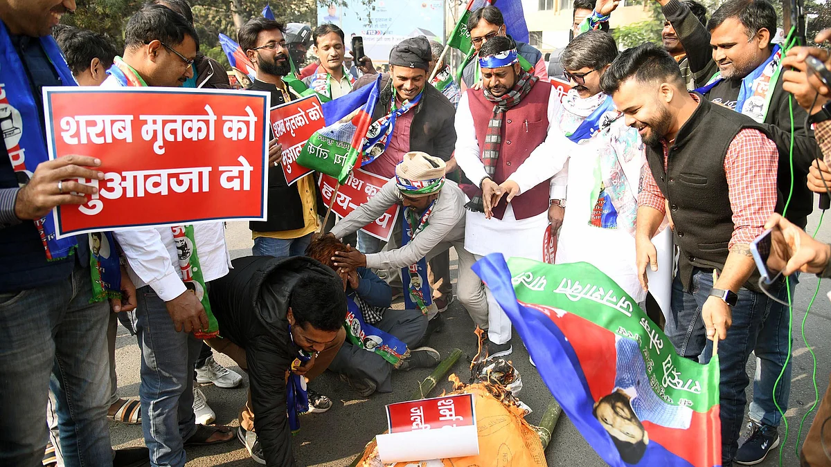 Members of Rashtriya Lok Janshakti Party (RLJP) burning effigy of Bihar CM Nitish Kumar for rejecting the demand of compensation for the family of victims of hooch tragedy in Chapra, at Income Tax roundabout on December 22, 2022 in Patna, India.