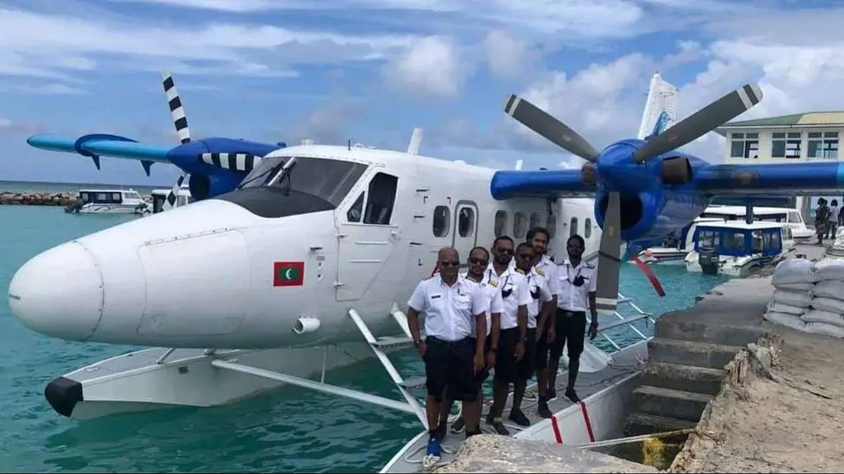 Southern Naval Command officers with the twin-engine seaplane that landed in Kochi to refuel
