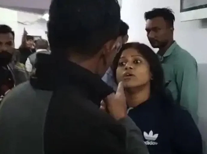 पुलिस से बहस करती आरोपियों के घर की महिला