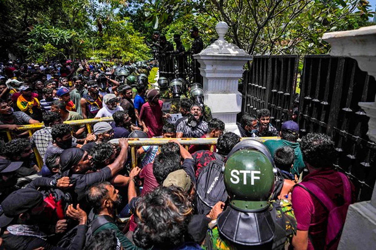 Protesters break down the gate as they storm the compound of Sri Lankan Prime Minister Ranil Wickremesinghe's office, demanding he resign after president Gotabaya Rajapaksa fled the country amid economic crisis in Colombo, Sri Lanka, July 13, 2022.