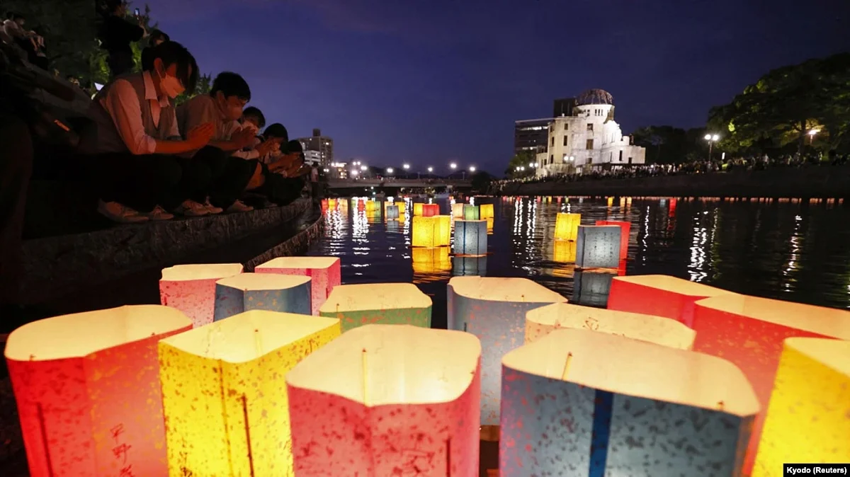 People release paper lanterns on the Motoyasu River facing the gutted Atomic Bomb Dome in remembrance of atomic bomb victims on the 77th anniversary of the bombing, in Hiroshima, Japan, on August 6, 2022, in this photo taken by Kyodo.