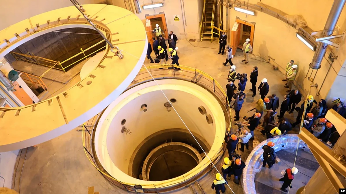 In this photo released by the Atomic Energy Organization of Iran, technicians work at the Arak heavy water reactor's secondary circuit, as officials and media visit the site, near Arak, 250 kilometers southwest of Tehran, Dec. 23, 2019.