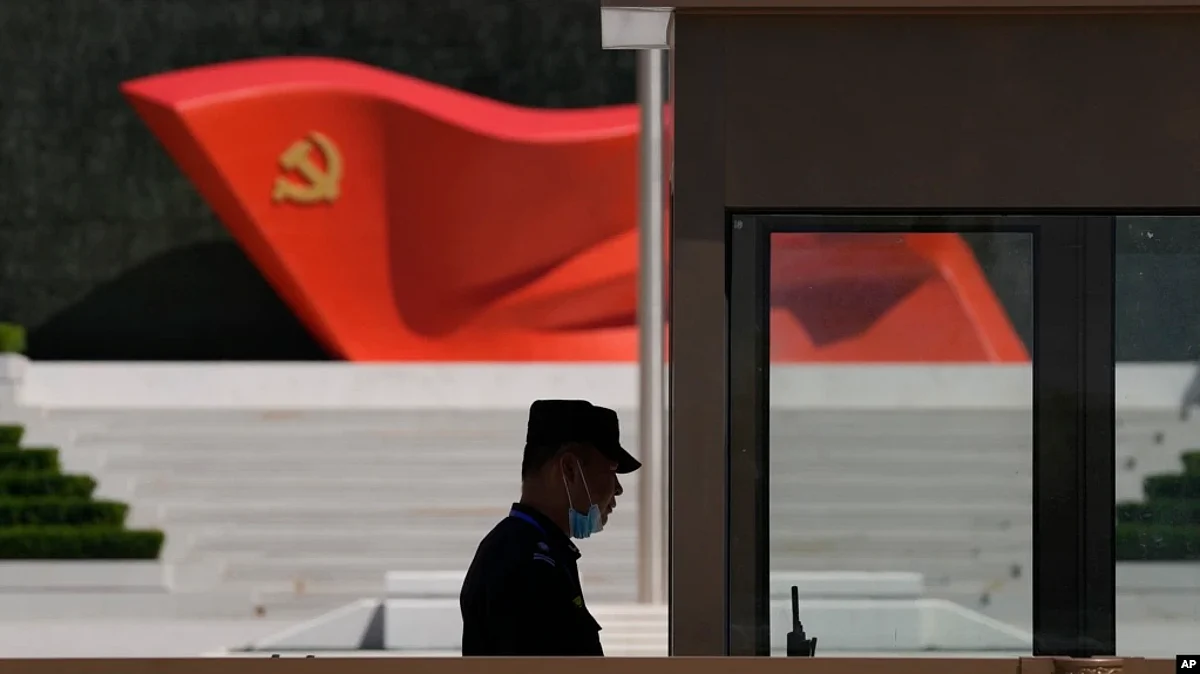 A security guard stands near a sculpture of the Chinese Communist Party flag at the Museum of the Communist Party of China on May 26, 2022, in Beijing. China said it was conducting military exercises July 30 off its coast.