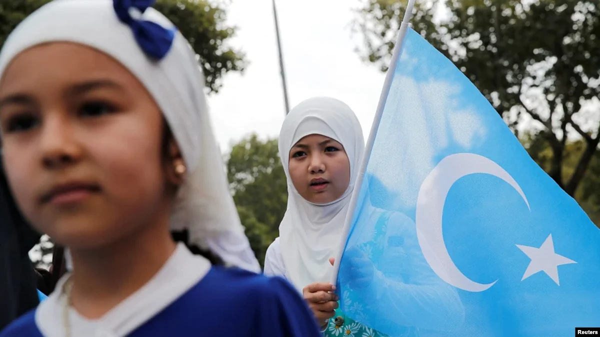 An ethnic Uyghur girl holds an East Turkestan flag during a protest against China, in Istanbul, Turkey Aug. 31, 2022.