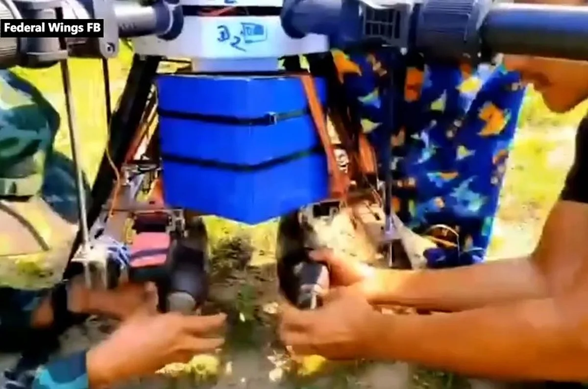 Members of Federal Wings prepare two munitions for a drone attack n Myanmar.
