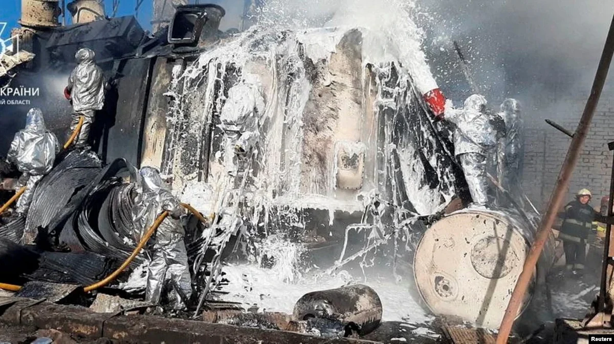 Firefighters work to put out a fire a thermal power plant damaged by a Russian missile strike, in Zhytomyr, Ukraine, Oct. 18, 2022.