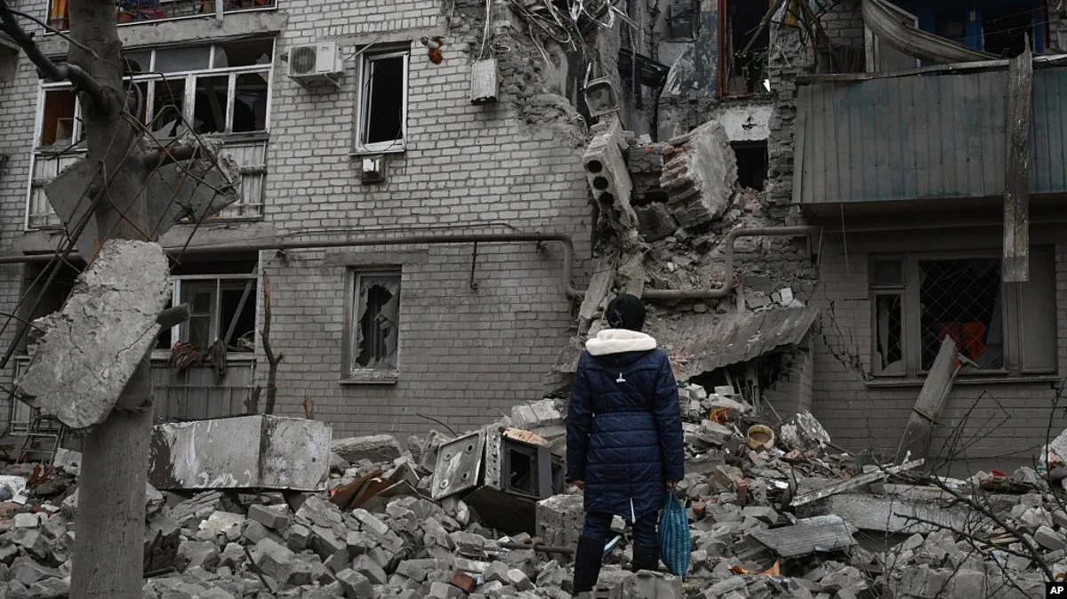 A woman stands among debris of the destroyed house after recent Russian air strike in Chasiv Yar, Ukraine, Nov. 27, 2022.