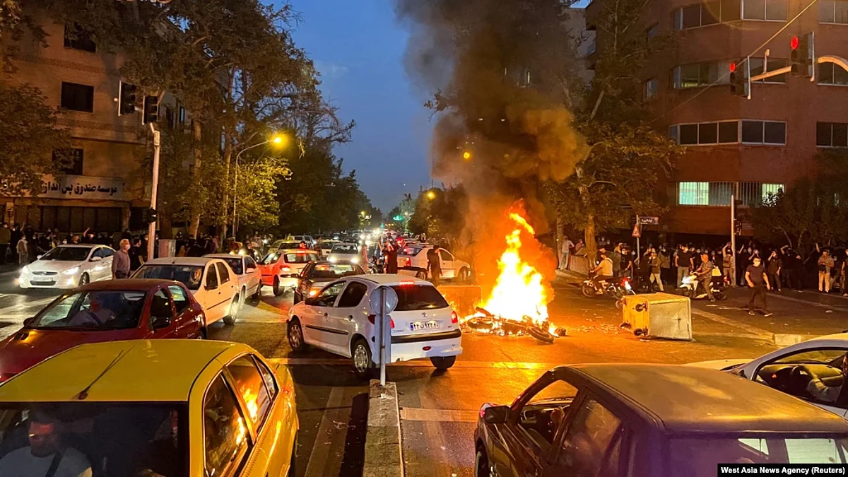 FILE - A police motorcycle burns during a protest over the death of Mahsa Amini, a woman who died after being arrested by the Islamic republic's "morality police", in Tehran, Iran, Sept. 19, 2022.