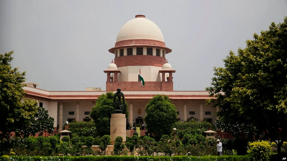 FILE - A gardener works on the lawns of the Supreme Court in New Delhi, Aug. 22, 2017. The court has agreed to hear petitions seeking legal recognition of same-sex marriages, raising hopes of securing another significant right for the country’s LGBTQ community.