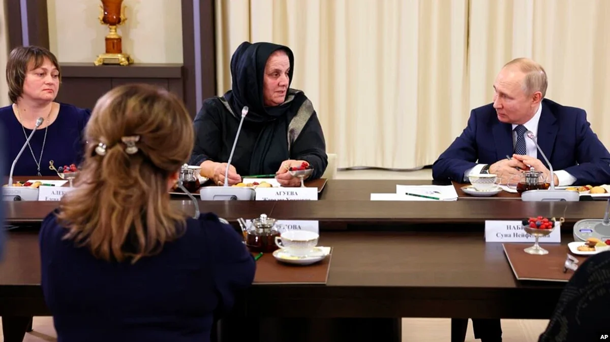 Russian President Vladimir Putin listens to Zharadat Agueva of the Chechen Republic during a meeting with mothers of personnel serving in the action against Ukraine, at the Novo-Ogaryovo presidential residence in suburban Moscow, Nov. 25, 2022.