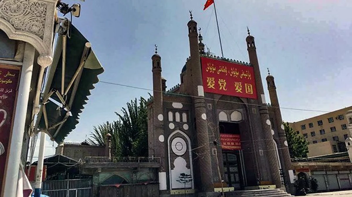 China's national flag and propaganda banners that read 'Love the Party, Love the Country' adorn the Jama Mosque in Kargilik county, Kashgar prefecture, northwestern China's Xinjiang region, in an undated photo.