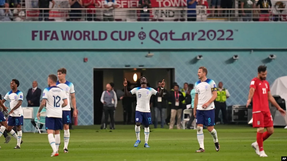 England's Bukayo Saka, center, celebrates after scoring his team's fourth goal during the FIFA World Cup group B soccer match between England and Iran at the Khalifa International Stadium in Doha, Qatar, Nov. 21, 2022.