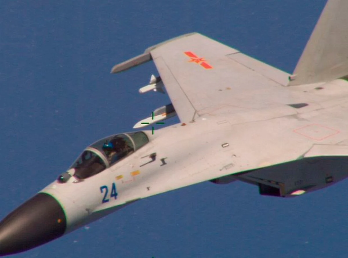 In this Aug. 2014 file photo, a Chinese J-11 fighter jet – the same type involved in the latest incident – flies near a U.S. Navy aircraft about 215 km (135 miles) east of China's Hainan Island. (Reuters/U.S. Navy/Handout)