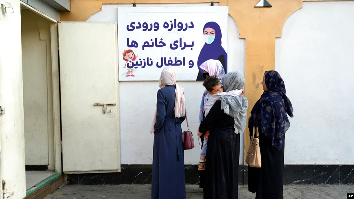 FILE - Afghan women stand outside an amusement park, in Kabul, Nov. 10, 2022. The Taliban banned women from using gyms and parks in Afghanistan, part of their crackdown on women's rights and freedoms. (AP)
