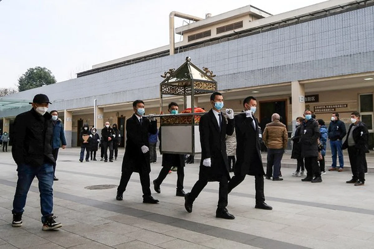 Staff members carry an urn in a funeral procession outside a crematorium of a funeral home in Chengdu, Sichuan province, China, Wednesday, Dec. 28, 2022.