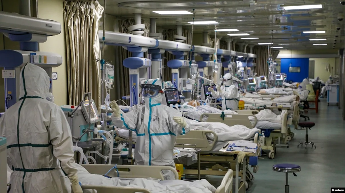 FILE - Medical workers in protective suits attend to COVID-19 patients at the intensive care unit of a designated hospital during the COVID-19 outbreak in Wuhan, China, Feb. 6, 2020. (China Daily via Reuters/File Photo)