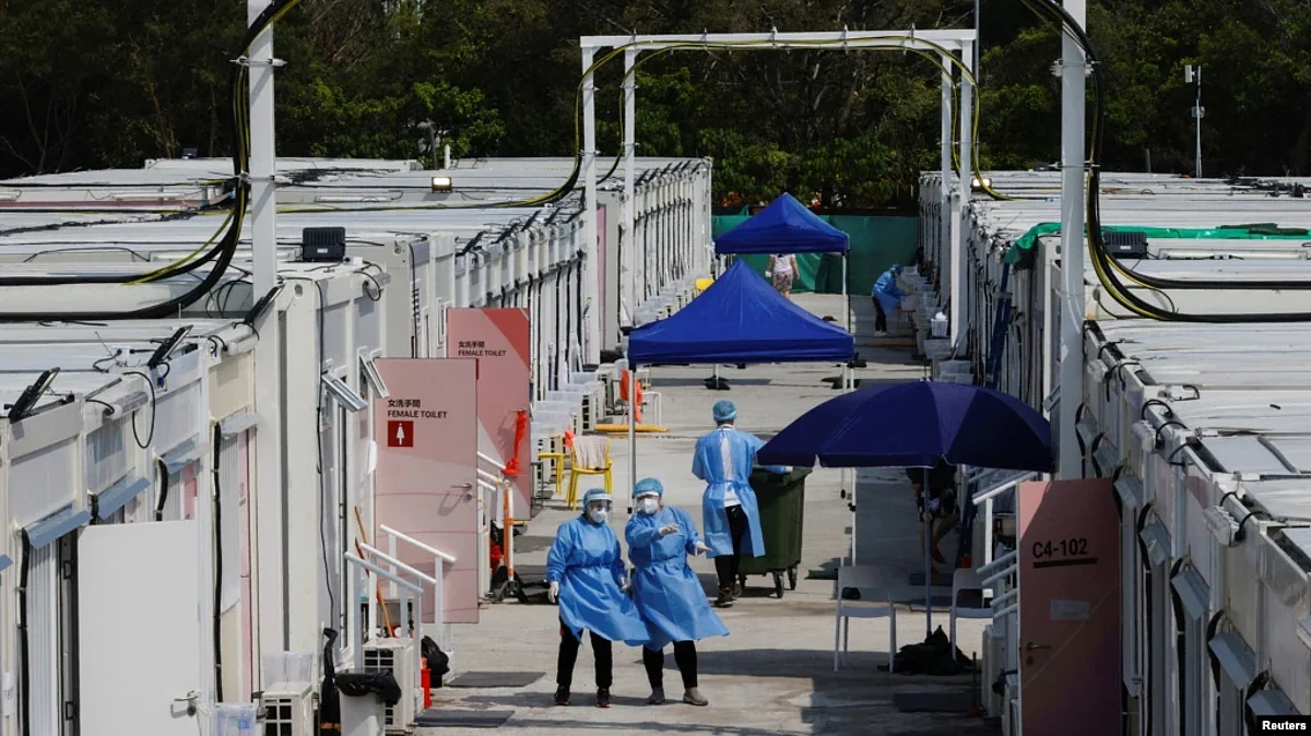 FILE - Workers wearing personal protective equipment work at a COVID-19 isolation facility, amid the pandemic, in Hong Kong, March 21, 2022. (Reuters)