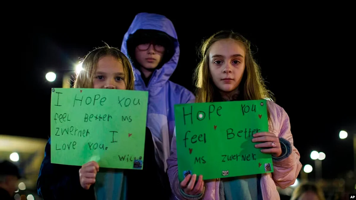 Willow Crawford, left, her sister Ava, right, and friend Kaylynn Vestre show support for Richneck Elementary School teacher Abby Zwerner during a vigil in Newport News, Va., Jan. 9, 2023. Zwerner was shot and wounded by a 6-year-old student Jan. 6. (AP)