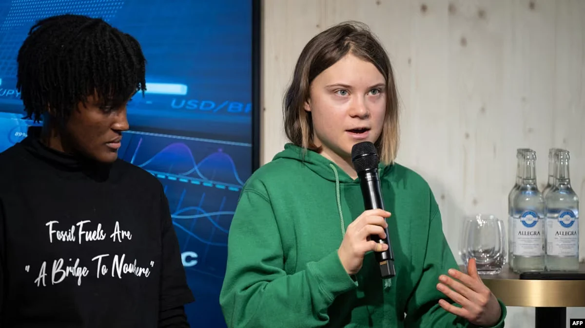 Swedish climate activist Greta Thunberg, right, speaks next to Ugandan colleague Vanessa Nakate during a session with International Energy Agency chief Fatih Birol, on the sidelines of the World Economic Forum in Davos, Switzerland, Jan. 19, 2023. (AFP)