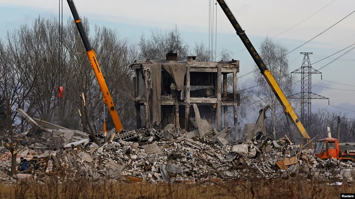 Workers remove debris of a destroyed building purported to be a vocational college used as temporary accommodation for Russian soldiers in Makiivka (Makeyevka), Russian-controlled Ukraine, Jan. 4, 2023. (Reuters)