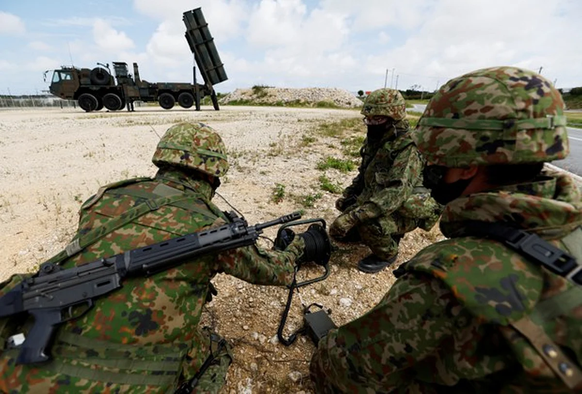 Japanese troops conduct a military drill next to an anti-ship missile unit, at Miyako camp on Miyako Island, Okinawa prefecture, on April 21, 2022. (Reuters/Issei Kato)