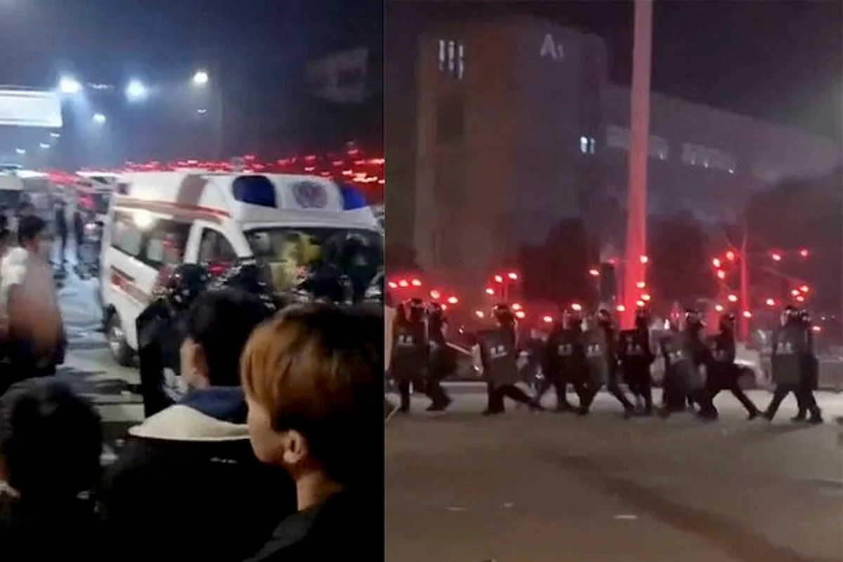 After a now-defunct COVID-19 test kit factory in Chongqing, China, announced layoffs, workers clashed with police over unpaid wages and benefits, Saturday, Jan. 7, 2023.(Reuters)