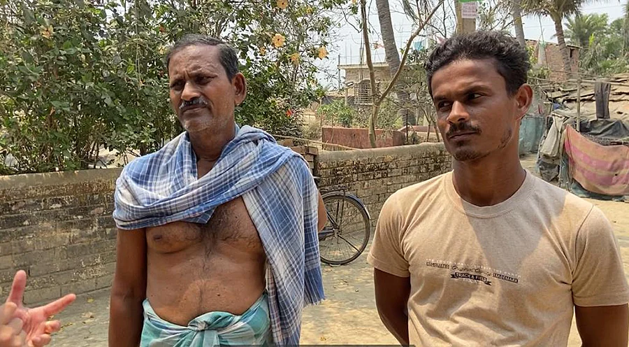 Rajab (left) and his son Rahman are both TMC party workers.
