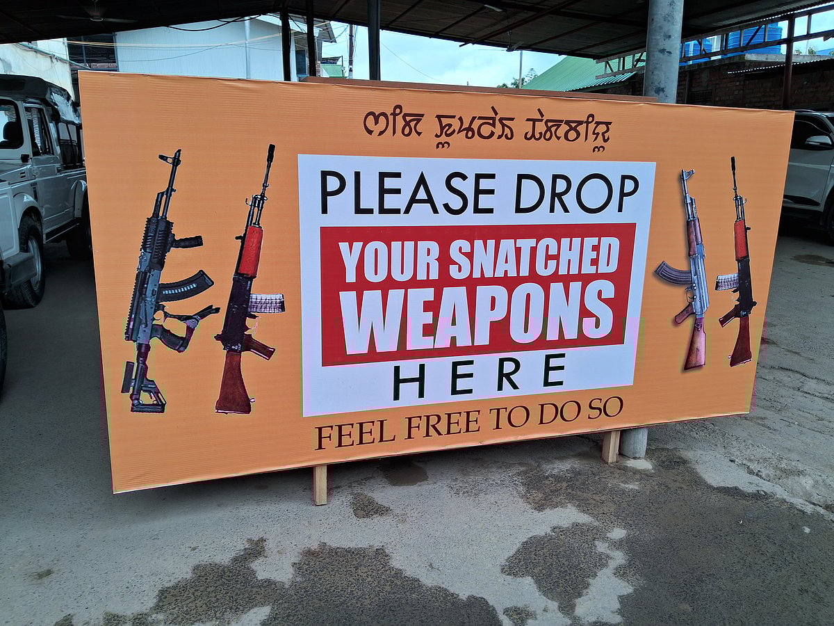 A board outside an MLA's house urges locals to return looted weapons, in Imphal.