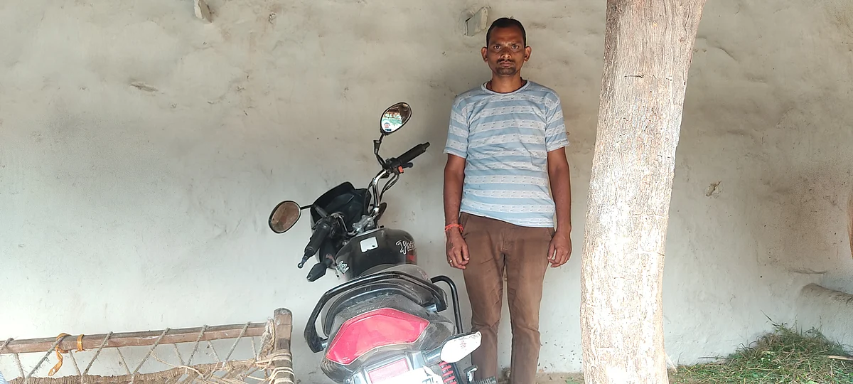 Lalchandra Yadav next to his bike on which he had gone to drop Bhalchandra for a court hearing.