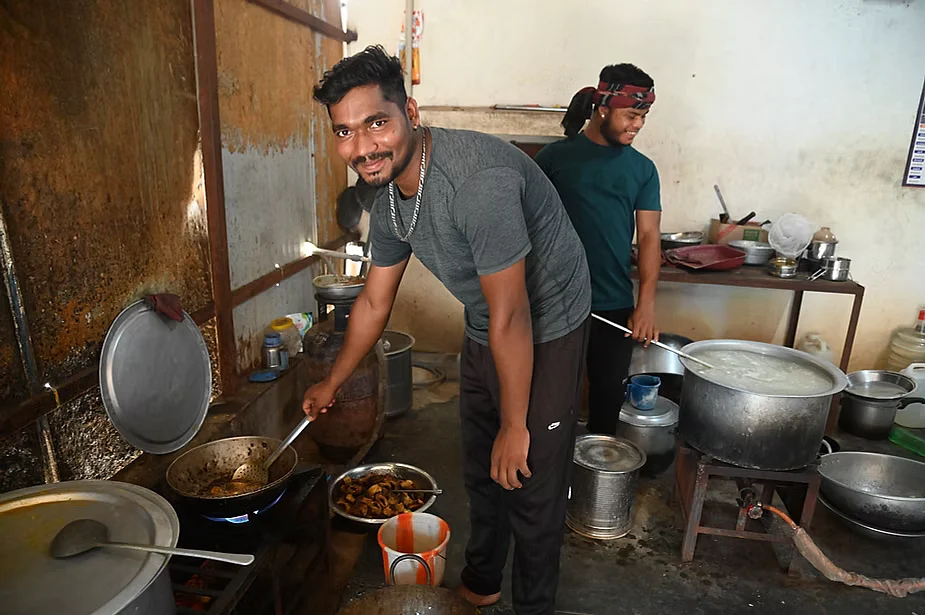 Workers from Odisha help out in a hostel kitchen in Vittalnayakanpatti in Dindigul district of Tamil Nadu. Mill workers usually don’t have access to cooling foods like cucumbers and buttermilk at the hostels where they live. 

