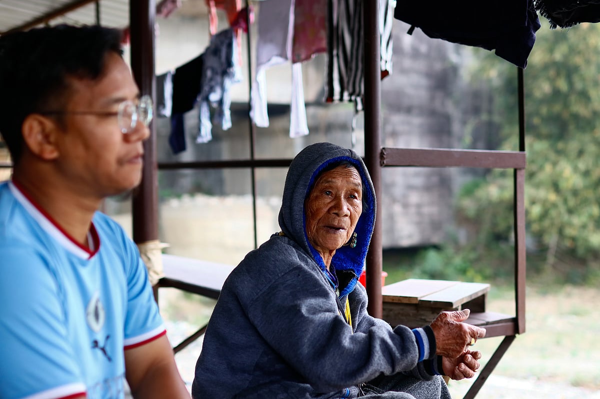 Tania Kipe sits with his mother, Yaji Kipe, a traditional priest, at their home near Karsinga Bridge, Arunachal Pradesh. 