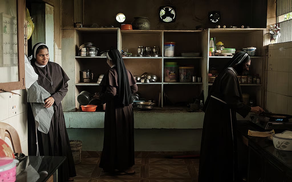 In the convent kitchen, three nuns prepare a meal. Photo: Isaac Nico