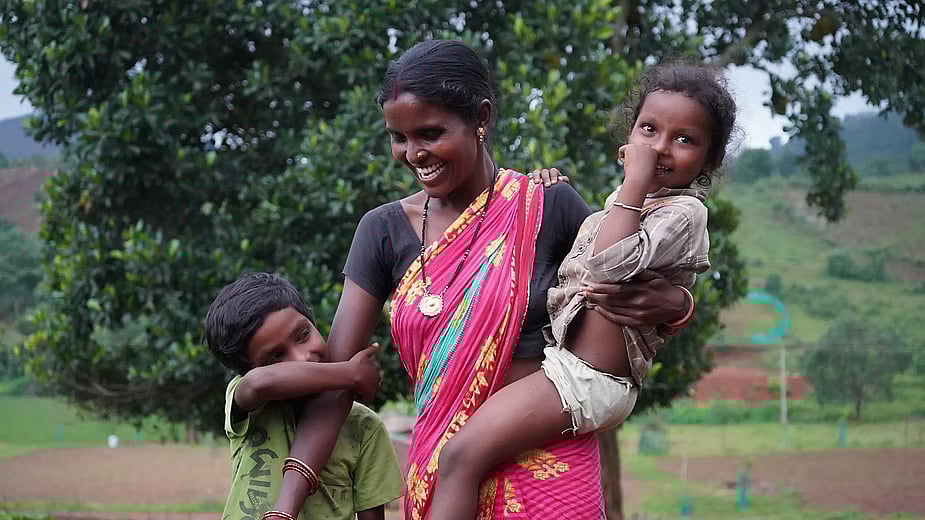 Umakant Naik’s wife, Pushpanjali, with their two younger children. Two older sons study in residential schools. Photo: Prajjwal Thakur