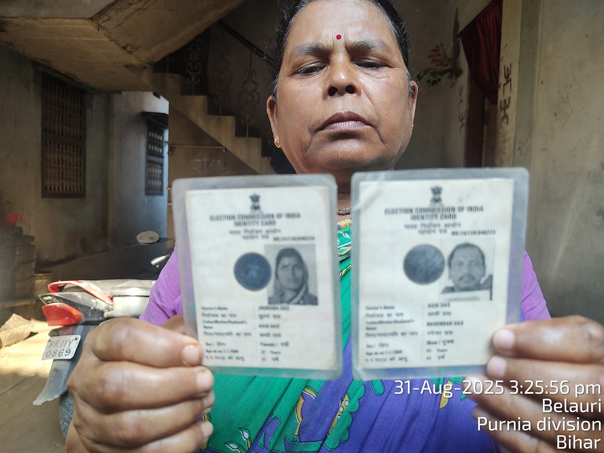 Jhurana Das showing her and her late husband's voter IDs.
