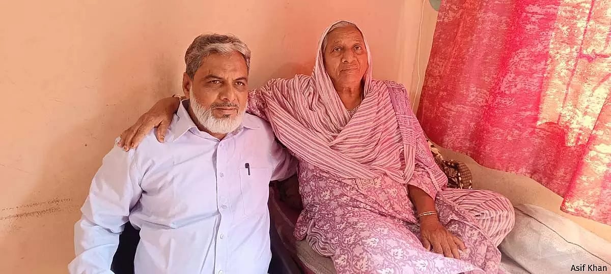 Asif Khan, 52, with his mother Husna Bano at home in Jalgaon, Maharashtra. He worked as a civil engineer in Mumbai before his arrest in 2006.