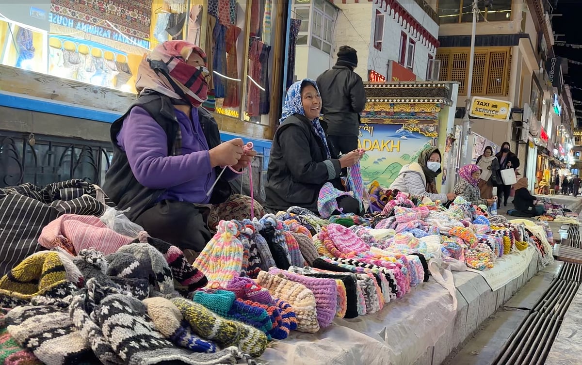 A group of Ladakhi women sat knitting beside piles of woollen caps and scarves.