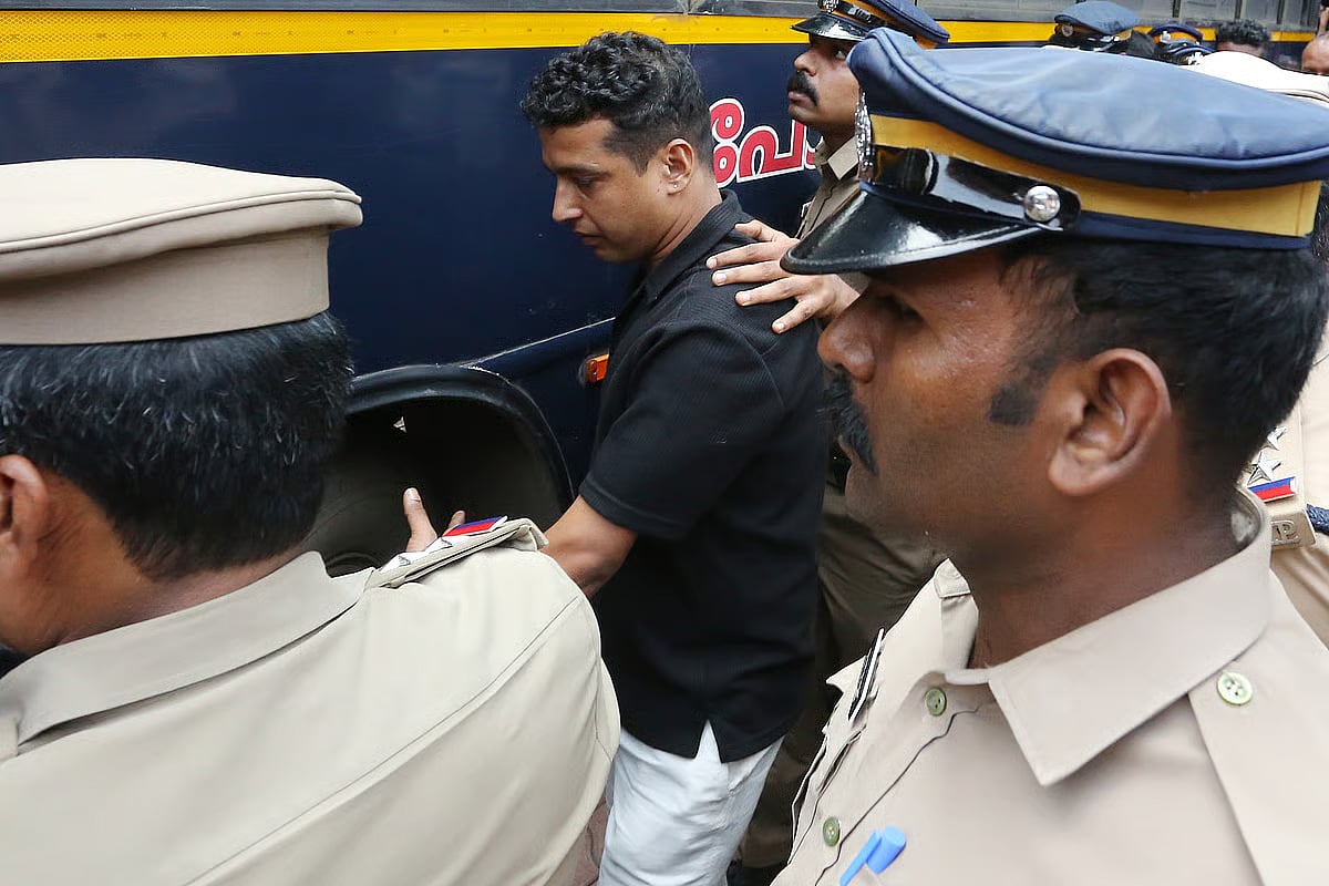 Pulsar Suni is taken to jail by police personnel post conviction.
