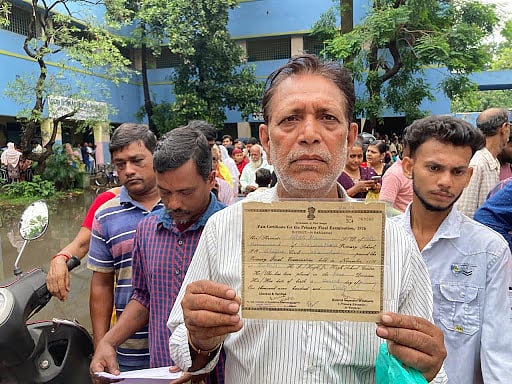Aftab Alam is holding his primary school exam certificate. (Image courtesy Suhasini Biswas)