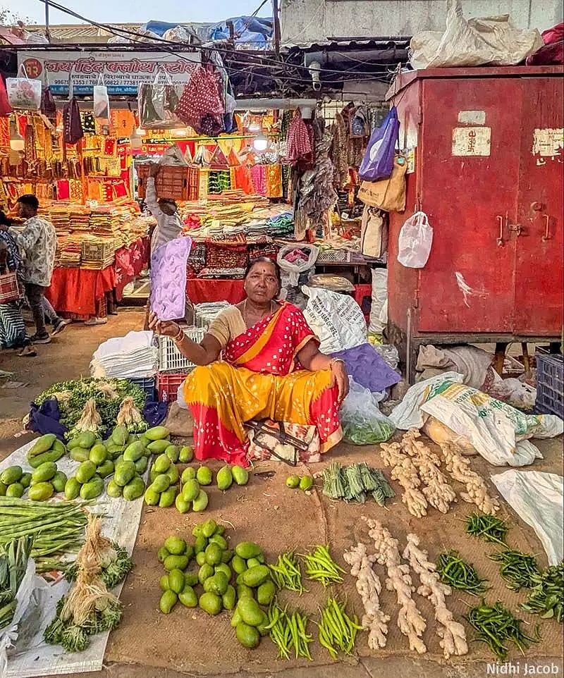 Sangeeta Sonawane, a vegetable vendor in Mumbai’s Borivali, uses a piece of thermocol to shield herself from the heat, but has little protection beyond that. (Image courtesy Nidhi Jacob)