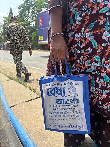 A lady carrying her documents outside the appellate tribunals. 