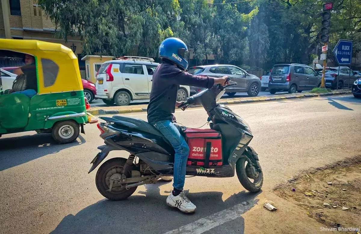 Riding a bike during a heatwave leaves Afzal’s face hot, and leads to weakness and dizziness. The government calls on platforms to provide safety kits, but they are not free. Workers make do with a cloth for protection. (Image courtesy Shivam Bhardwaj)